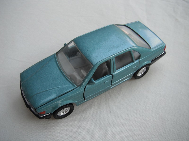 5. Metallic lt.blue body/black China base/8 dot disc wheels/clear windows/lt.gray interior/white rear license plate.