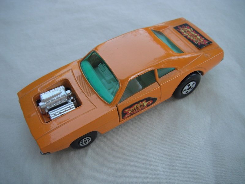 9. Orange body/unpainted base/lt.green windows/spiro &amp; five spoke wheels/&quot;Dinamite&quot; labels on side doors and rear.