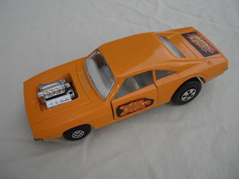 8. Lt.Orange body/unpainted base/clear windows/spiro &amp; five spoke wheels/&quot;Dinamite&quot; labels on side doors and rear.