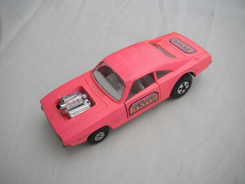 6. Pink body/unpainted base/clear windows/spiro &amp; five spoke wheels/&quot;Binder&quot; labels on side doors &amp; rear.