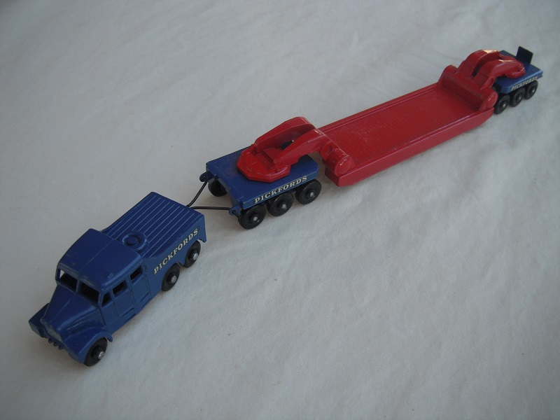 6. Blue tractor/black base/FBPW/silver radiator/bright red &amp; blue trailer/FBPW/unpainted tow bar/Pickfords decals.