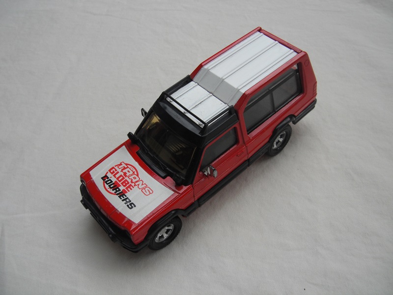 5. Red body/white roof/red metal base/England/amber windshield/clear windows/black interior/&quot;Trans Globe Couriers&quot; on hood.