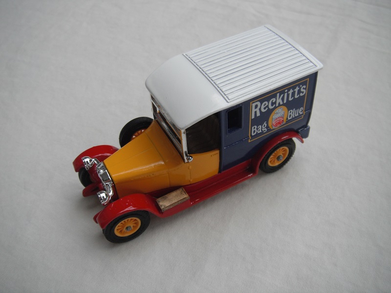 7.  Yellow bonnet/blue rear/white roof/rectangular side windows/red base/England/12 spoke yellow wheels.