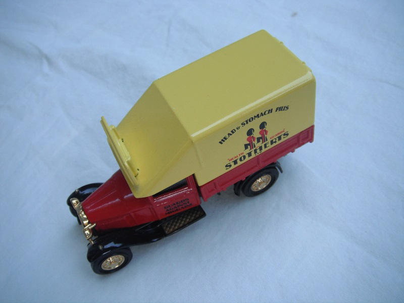 2. Ford AA Truck/Red cab/red bed/yellow canopy w/roof blade/black base/China/solid gold wheels/black seat.