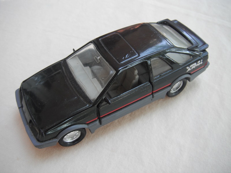 27. Black body &amp; spoiler/gray Macau base/8 dot chrome disc wheels/clear windows/gray int/gray steering wheel/red stripe/large XR4i.