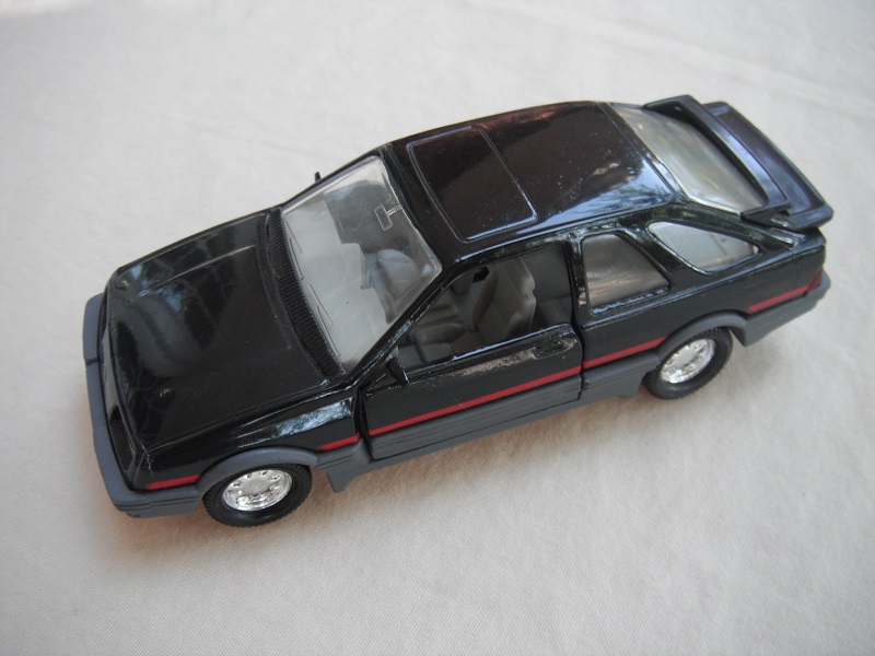 26. Black body &amp; spoiler/gray Macau base/8 dot chrome disc wheels/clear windows/gray int/gray steering wheel/red stripe.