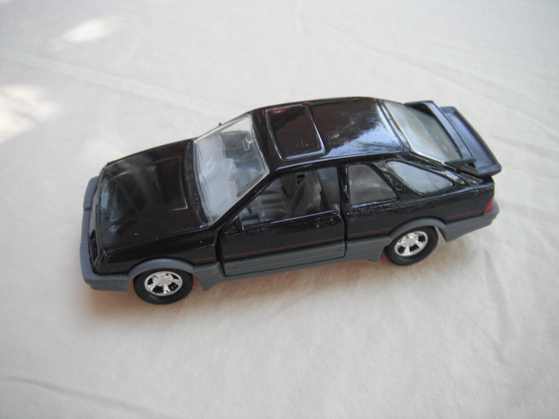 25. Black body &amp; spoiler/gray England base/5 spoke mag wheels/clear windows/gray int/gray steering wheel/thin red stripe.