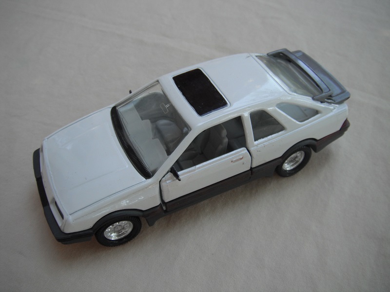 13. White body/gray spoiler/gray England base/8 dot chrome disc wheels/clear windows/gray int/black steering wheel/roof label.