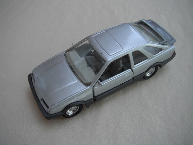 6. Silver body/gray spoiler/black England base/8 dot chrome disc wheels/clear windows/gray int/black steering wheel/PP.