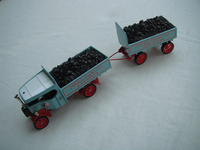 6. Pale blue body/white roof/red chassis/red base/Y27/England/red Y spoke wheels/load of coal/No. 5. (includes trailer).