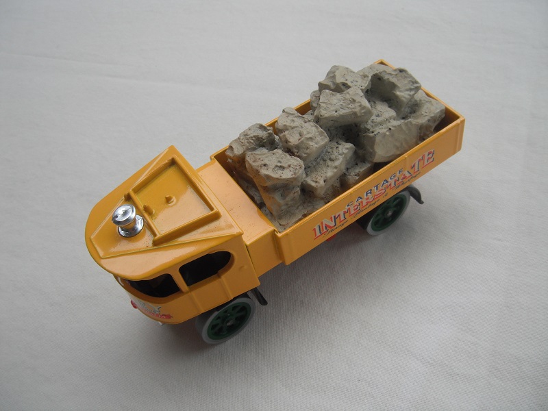 2. Yellow cab/short yellow bed/red base/green wheels/load of stones.