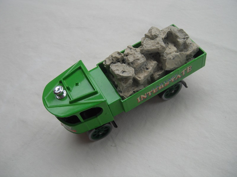 1. Green cab/short green bed/red base/green wheels/load of stones.