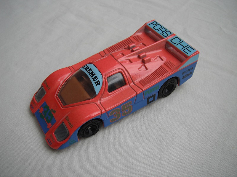 18.Orange-red, light &amp; dark blue body/black base/China/clear windows/brown interior/unchromed wheels/Porsche Kremer #35.