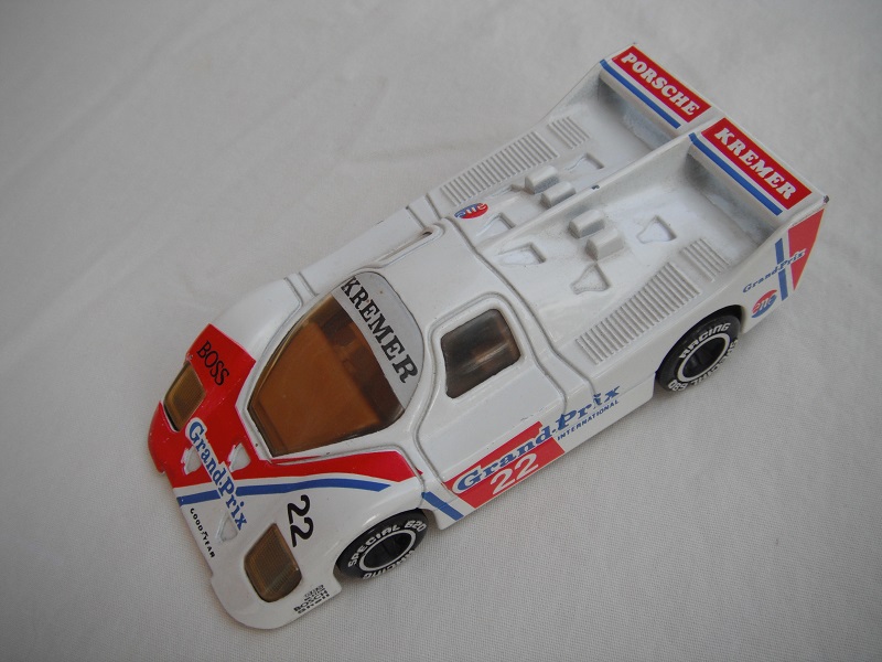 11.White &amp; red body/black base/Macau/lt.amber windows/brown interior/chromed lettering on wheels/Kremer Grand-Prix #22.