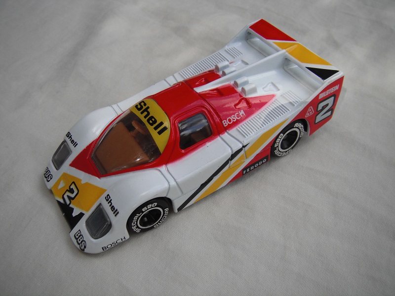 6. White, red &amp; yellow body/black base/China/clear windows/lt.brown interior/chromed lettering on wheels/Shell #2.