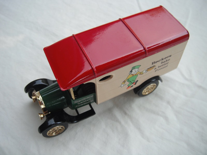 7. Green bonnet/tan body/dark red roof/black base/China/12 spoke gold wheels/gray seat/no printed treads on cab steps/no cast sidelights.