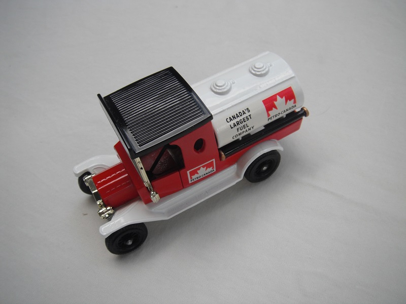 1. Red cab/black roof/white tank/white base/Matchbox England/12 spoke black wheels/pinky-tan seat.