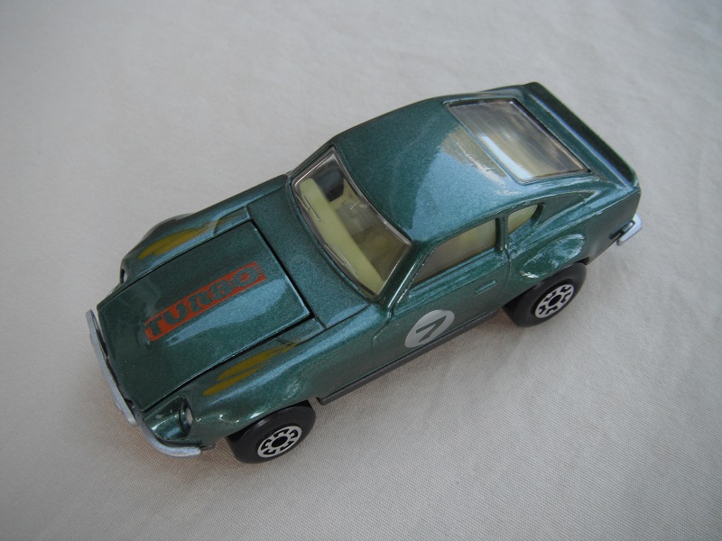 B146. Metallic green body/charcoal base/lt.yellow interior/5 arch front, 5 crown rear wheels/&quot;7&quot; on door.