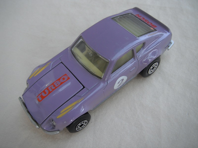 B130. Light purple body/silver base/light yellow interior/5 arch front, 5 crown rear wheels/&quot;2&quot; on door &amp; Turbo on hood.