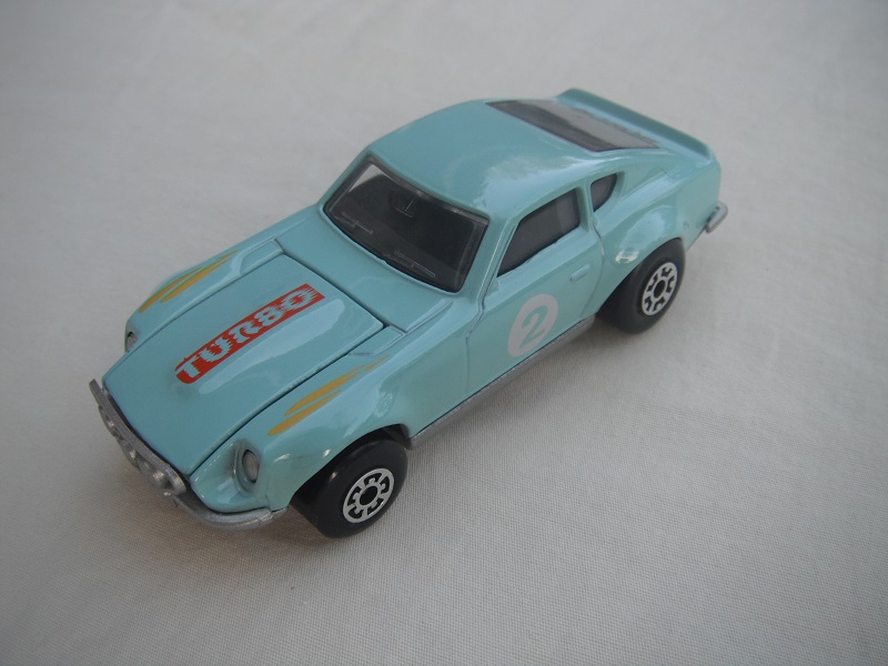 B127. Light blue body/silver base/black interior/5 arch front, 5 crown rear wheels/&quot;2&quot; on door &amp; Turbo on hood.