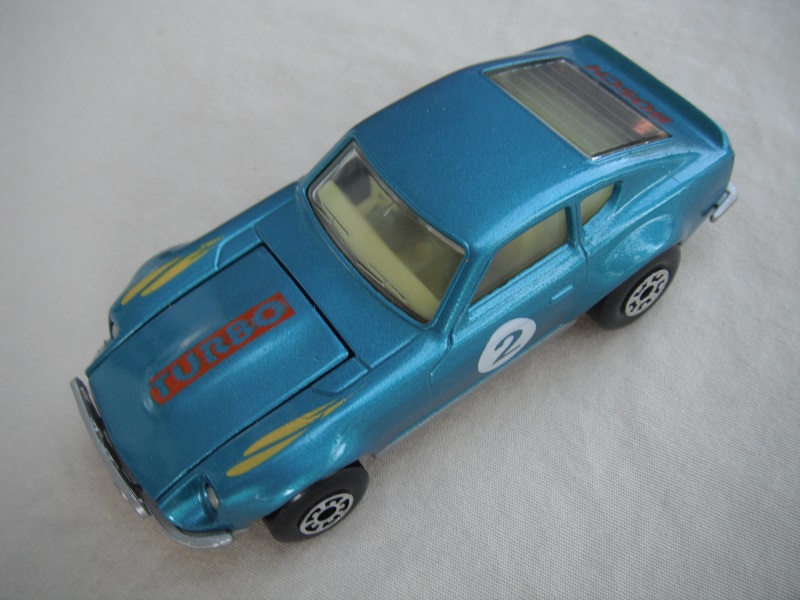B125. Blue body/silver base/black interior/5 arch front, 5 crown rear wheels/&quot;2&quot; on door &amp; Turbo on hood.