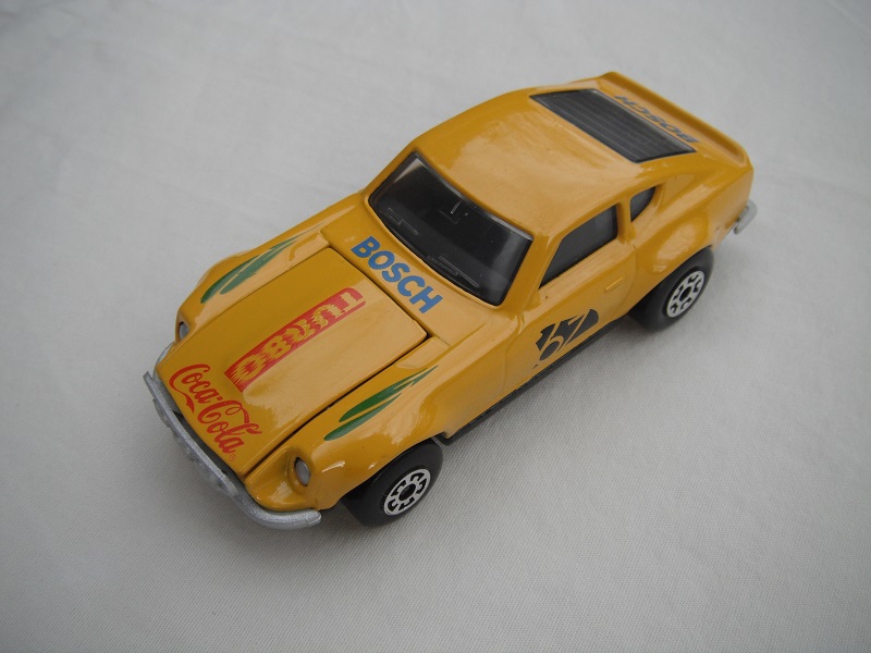 B119. Dark yellow body/gloss black base/black interior/5 arch front, 5 crown rear wheels/&quot;67&quot; &amp; Turbo Coca Cola on hood/green fenders decals.