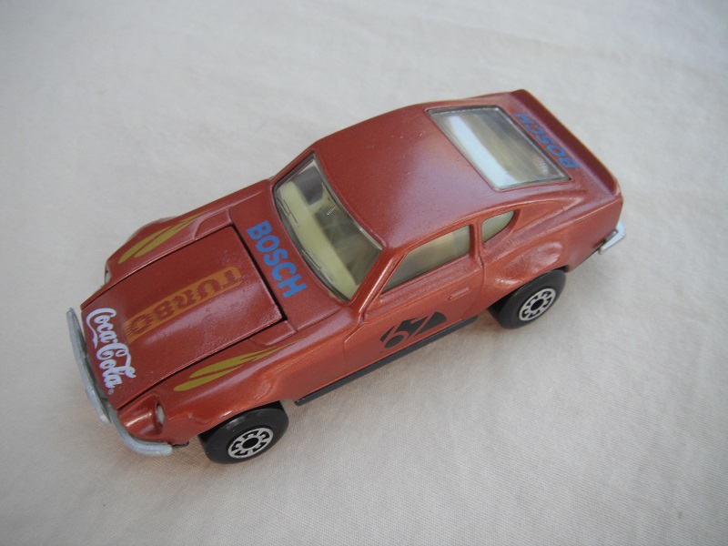 B116. Met. brown body/charcoal base/lt.yellow interior/5 arch wheels/&quot;67&quot; &amp; Turbo Coca Cola on hood/green fenders decals.