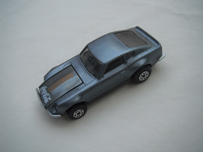 B110. Silver body/charcoal base/black interior/5 arch front, 5 crown rear wheels/Turbo &amp; Coca Cola on hood.