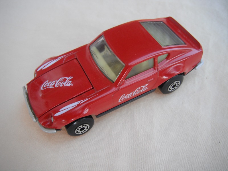 B104. Red body/charcoal base/light yellow interior/5 arch wheels/Coca Cola decals.