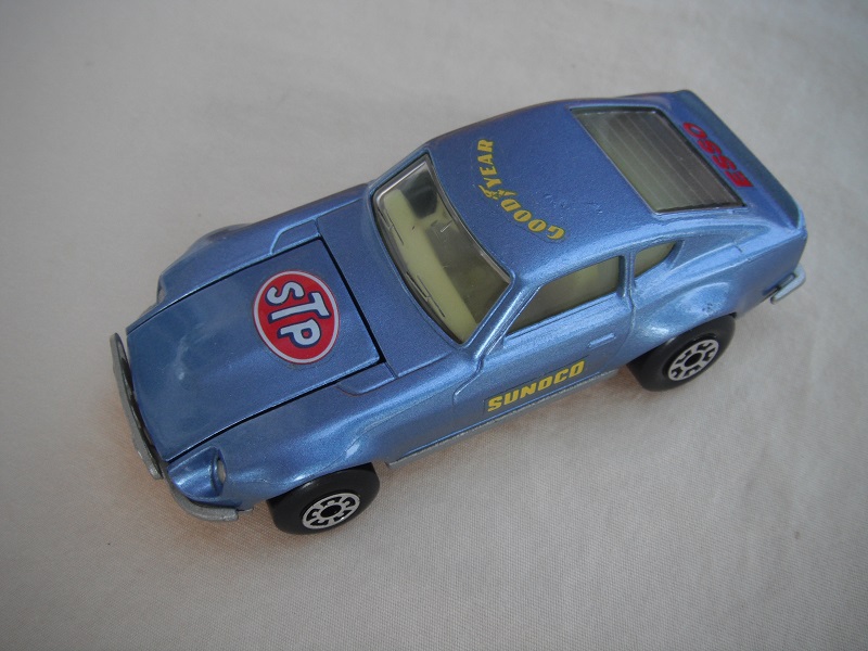 B95. Metallic light blue body/silver base/light yellow interior/5 arch front, 5 crown rear wheels/Sunoco &amp; STP decals.