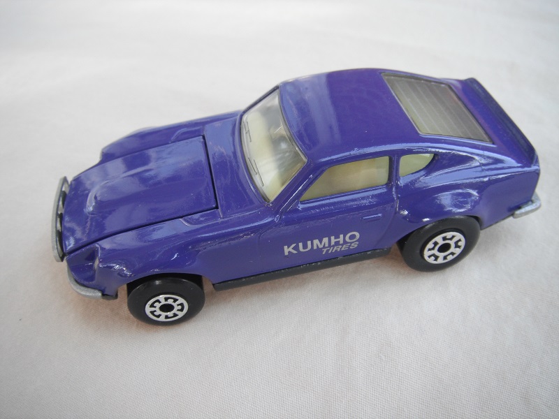 B77. Purple body/charcoal base/light yellow interior/5 arch front, 5 crown rear wheels/Kumho Tires decals.