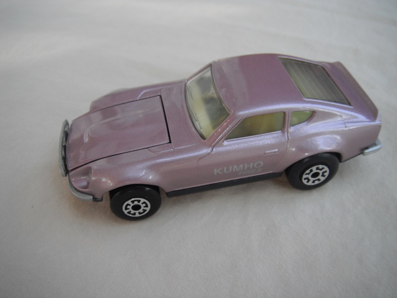B76. Metallic lt.purple body/charcoal base/light yellow interior/5 arch front, 5 crown rear wheels/Kumho Tires decals.