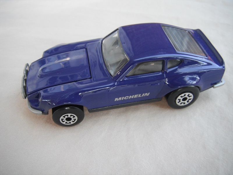 B74. Blue body/charcoal base/black interior/5 arch front, 5 crown rear wheels/Michelin decals.