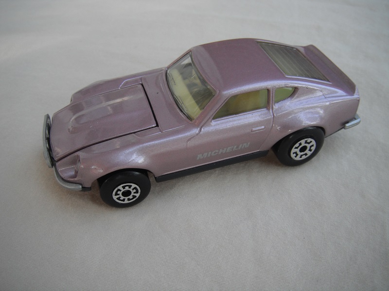 B73. Metallic pink body/charcoal base/light yellow interior/5 arch front 5 crown rear wheels/Michelin decals.