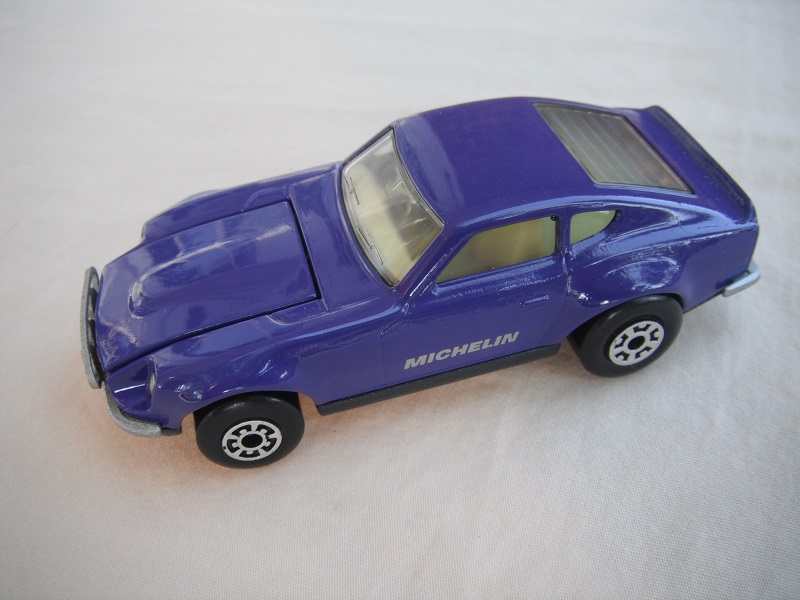 B72. Purple body/charcoal base/light yellow interior/5 arch front, 5 crown rear wheels/Michelin decals.