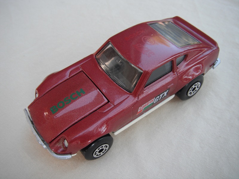 B65. Maroon body/cream base/black interior/5 arch front 5 crown rear wheels/Castrol/GTX decals.