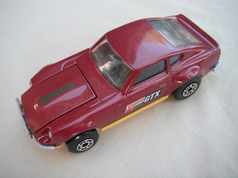 B63. Maroon body/dark yellow base/black interior/5 arch front, 5 crown rear wheels/Castrol/GTX decals.