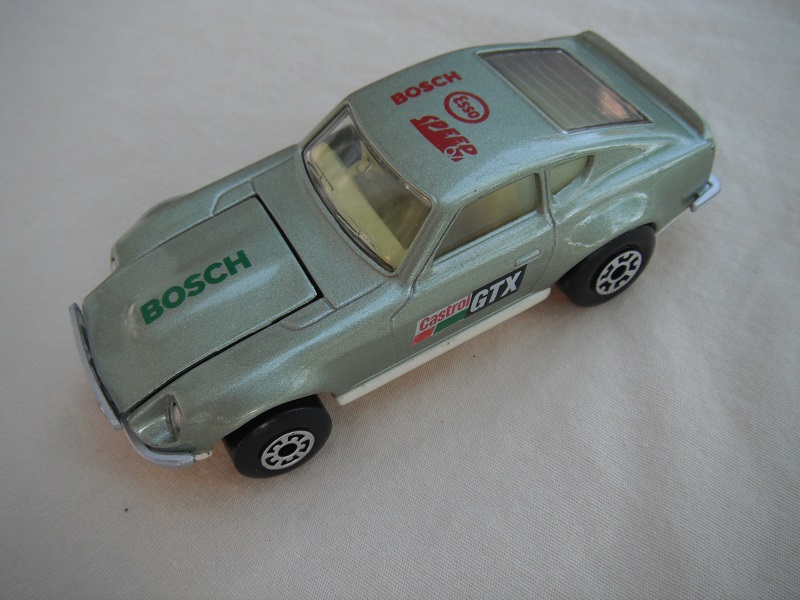 B53. Metallic silver body/cream base/light yellow interior/5 arch front, 5 crown rear wheels/Castrol/GTX decals.