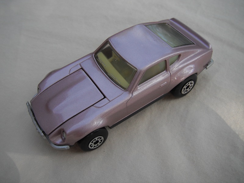 B36. Mauve body/charcoal base/light yellow interior/5 arch front, 5 crown rear wheels.