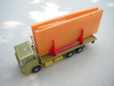 11.Olive green body/lt.yellow K-13/20 base/clear windows/white int/4 spoke wheels/black open axle cover/orange building.