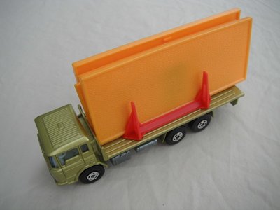 9. Olive green body/unpainted K-13 base/blue tint windows/white int/5 spoke star wheels/black open axle cover/orange building.