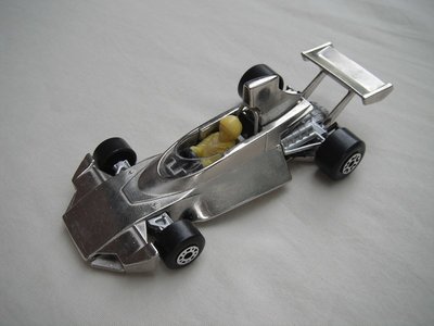 B9. Silver plated body &amp; base/dot-dash front, large 5 crown rear wheels/silver plated airfoil/yellow driver.