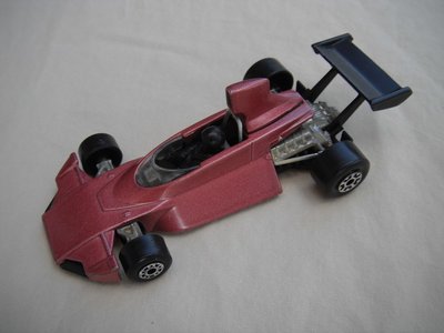B4. Lavender body/black base/dot-dash front, large 5 crown rear wheels/black airfoil/black driver.