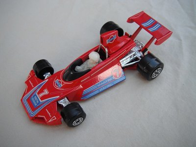 E7. Red body/blu &amp; wht stripes/red base/wide rear whls/white driver w/large white helmet/&quot;Martini&quot; &amp; &quot;7&quot; decals.