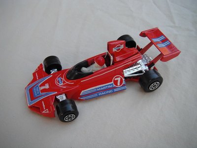 E4. Red body/blu &amp; wht stripes/red base/narrow rear whls/white driver w/large red helmet/&quot;Martini&quot; &amp; &quot;7&quot; decals.